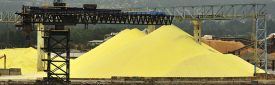 Piles of Yellow Sulphur on Dock at Chemical Processing Factory